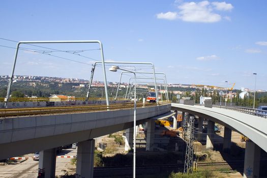 a new tram going down a new bridge in the city