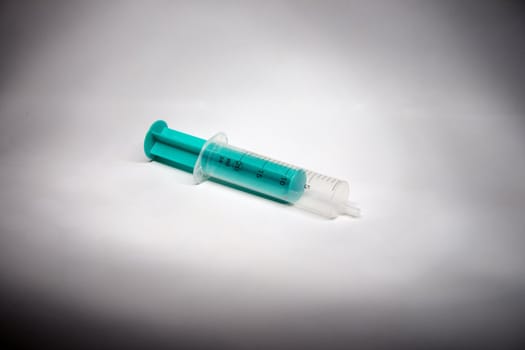 A common clinical syringe (green) - close up