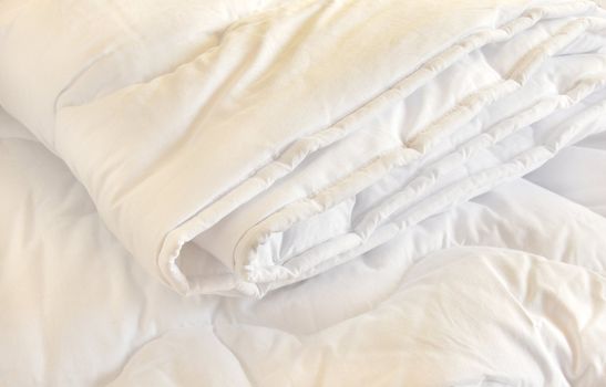 white folded cotton duvet background