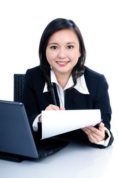 Portrait of a beautiful businesswoman holding clipboard and writing, over white background.