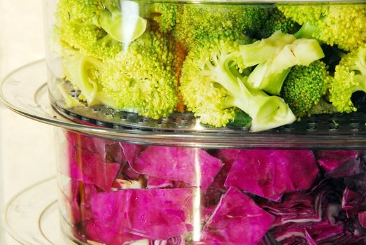 fresh green broccoli and magenta cabbage in steamer