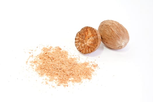 Whole and grated nutmeg isolated on white background