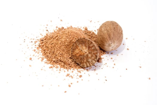 Whole and grated nutmeg isolated on white background