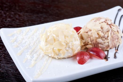 Dessert set of ice-cream with almond, chocolate and grapes