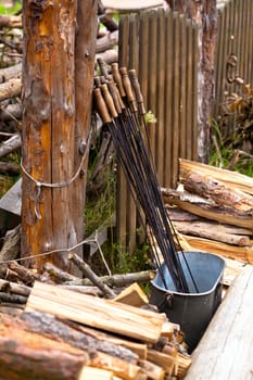 Wooden fence and steel sticks for barbecue
