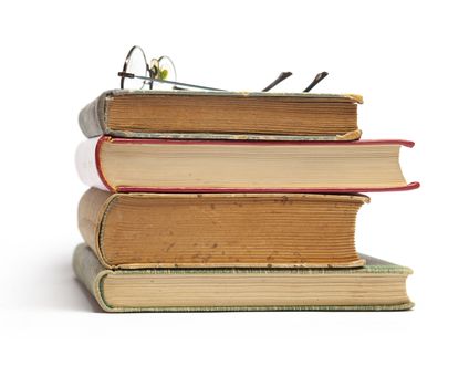 Group of Old Antique Books and eyeglasses isolated on white