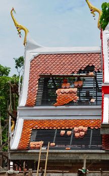 Repairing the roof of a temple in Thailand