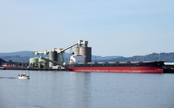 A cargo ship receiving a load in the port of Longview Washington.