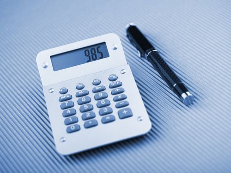 Calculator and pen on office table