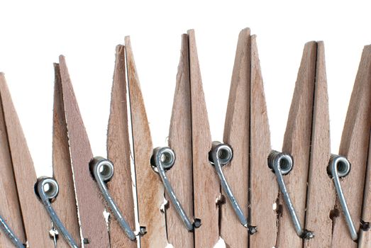 Wooden clothes pegs isolated on white background.