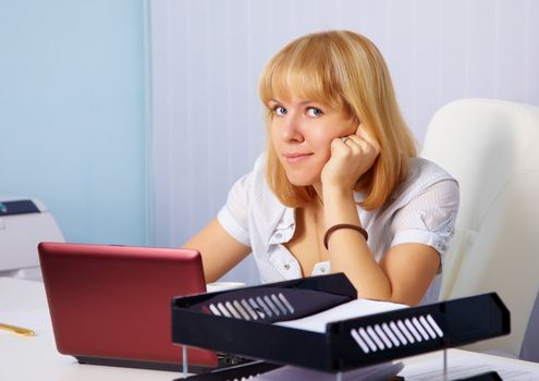 A young woman in the workplace in the office