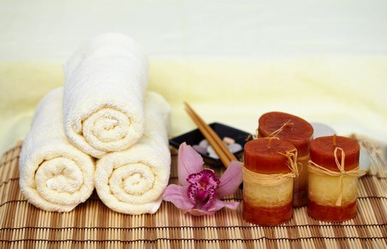 Still life on a theme a spa - a candle, mat, towels