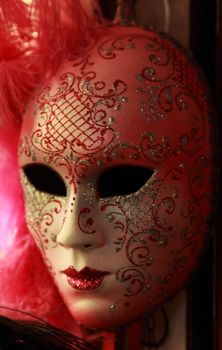 Image of a beautiful Venetian mask on a souvenir shop stand in natural lighting conditions.Soft focus.