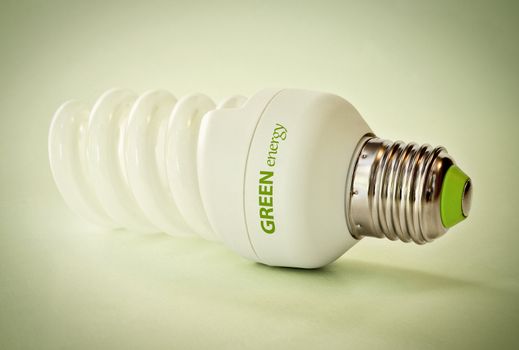 Close up of a light bulb on green background