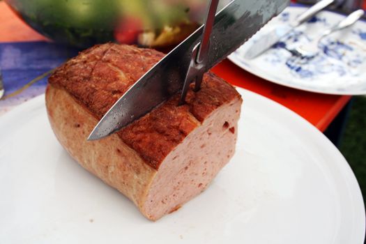 Fresh meat loaf is cut into several pieces