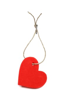 Red paper heart hanging on white background with rope and nail