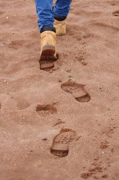 Human footprints on sandy beach
