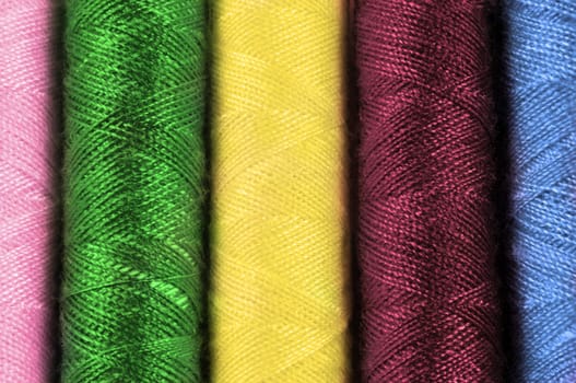 Close up on cotton thread reels of various colours
