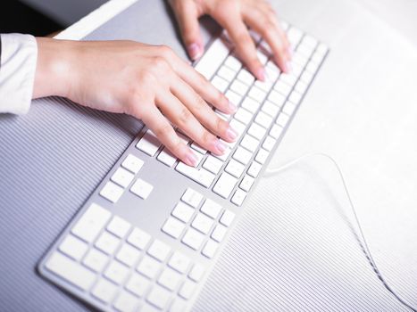Business Secretary Typing on Computer Keyboard