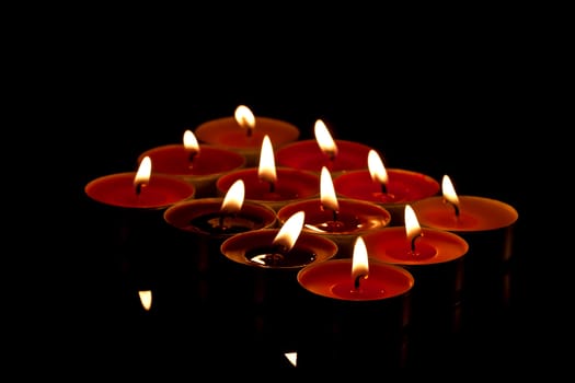 colored candles on black background