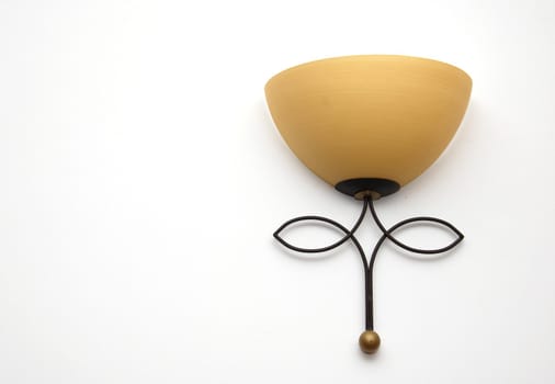 one yellow rustic lamp on white wall