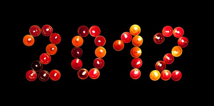 2012 made ​​of colored candles on a black background