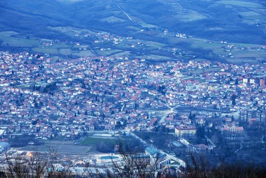blue twilight rural landscape of Serbia, houses red roofs