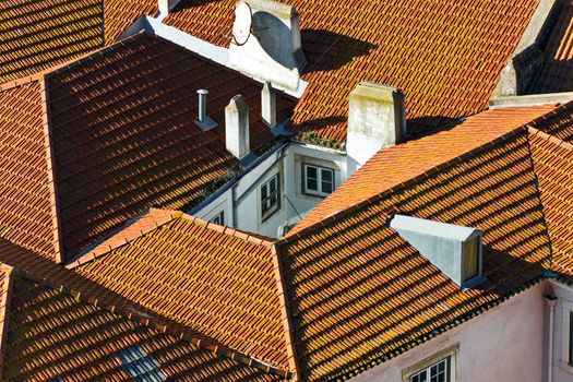roof covered with red tiles, narrow well