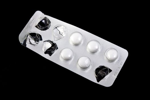 used packaging of pills, black background, isolated