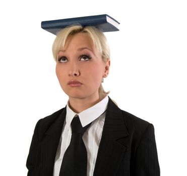 Blonde girl holds the book on a head is isolated on a white background.
