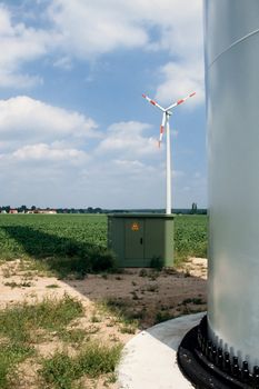Windfarm in rural setting: wind turbine, transformer and footing of tower all embedded in farmland