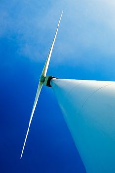 Wind turbine with dual wing rotor, shot from underneath at base of tower