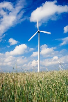 Wind turbines/ windfarm on farmland (motion blur on rotors)