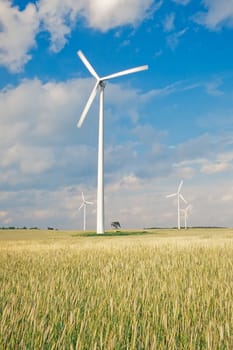 Wind turbines/ windfarm on farmland (slight motion blur on rotors)