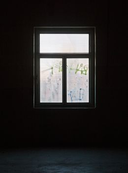 Window with bad condition in a worn dark building