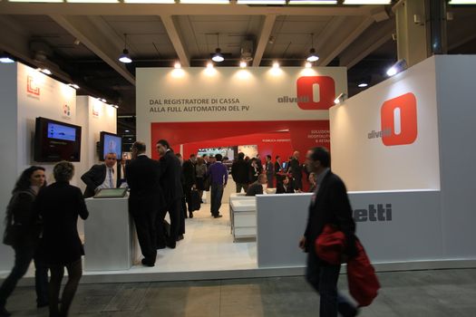 People visit Olivetti technologies stand during SMAU, international fair of business intelligence and information technology in Milan, Italy.