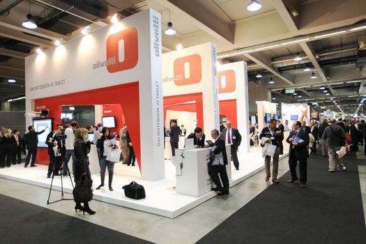 People visit Olivetti technologies stand during SMAU, international fair of business intelligence and information technology in Milan, Italy.