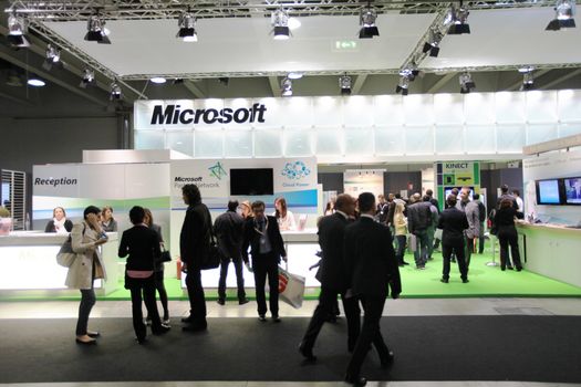 People visit Microsoft technologies stand during SMAU, international fair of business intelligence and information technology in Milan, Italy.