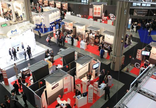 Panoramic view of people visiting technologies stands during SMAU, international fair of business intelligence and information technology in Milan, Italy.