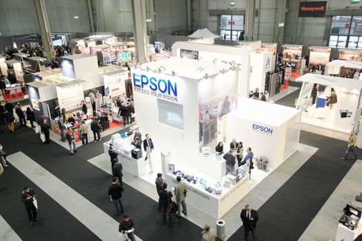 Panoramic view of people visiting technologies stands during SMAU, international fair of business intelligence and information technology in Milan, Italy.