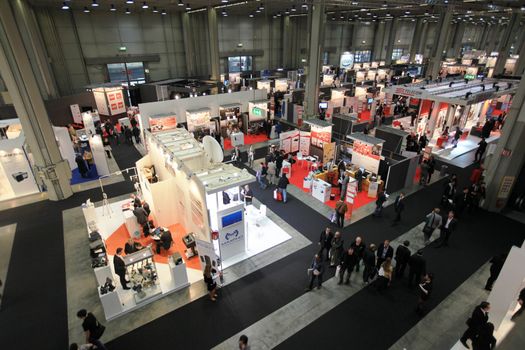 Panoramic view of people visiting technologies stands during SMAU, international fair of business intelligence and information technology in Milan, Italy.