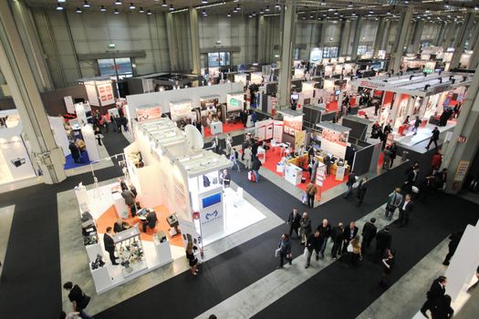 Panoramic view of people visiting technologies stands during SMAU, international fair of business intelligence and information technology in Milan, Italy.