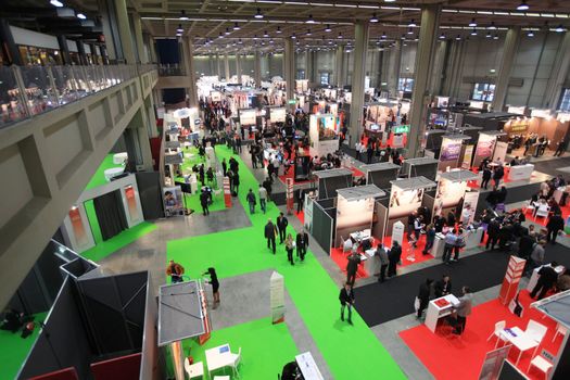 Panoramic view of people visiting technologies stands during SMAU, international fair of business intelligence and information technology in Milan, Italy.