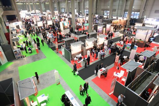 Panoramic view of people visiting technologies stands during SMAU, international fair of business intelligence and information technology in Milan, Italy.