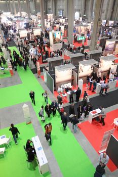 Panoramic view of people visiting technologies stands during SMAU, international fair of business intelligence and information technology in Milan, Italy.