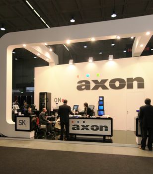 People visit Axon technologies stand during SMAU, international fair of business intelligence and information technology in Milan, Italy.
