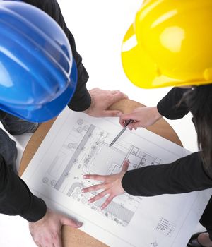 Two architects with hard hats and plan on meeting in office