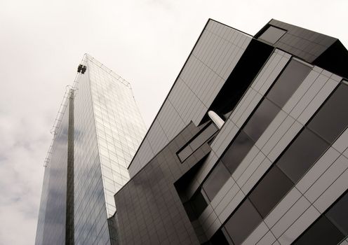 Modern office high building is constructed of glass and concrete