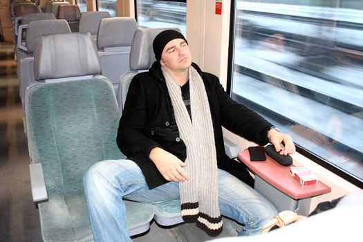 Young man traveling by train through Germany