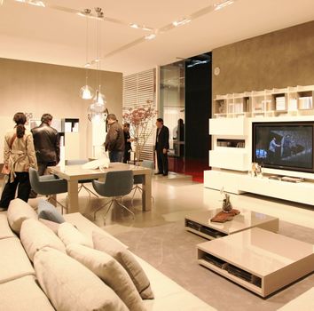 People look at interiors design stands and home architecture solutions visiting 2011 Salone del Mobile, international furnishing accessories exhibition in Milan, Italy.